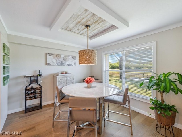 dining area with light wood-type flooring and baseboards