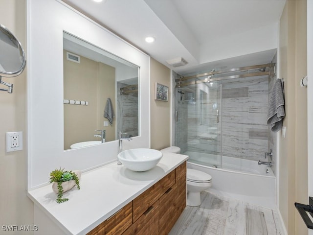bathroom with toilet, vanity, recessed lighting, and enclosed tub / shower combo