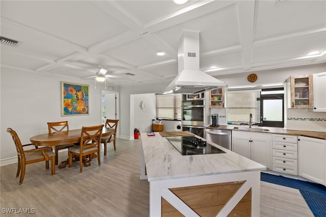 3275 Boca Ciega Dr Unit D49, Naples, FL 34112 - kitchen featuring a sink, coffered ceiling, appliances with stainless steel finishes, light wood finished floors, and white cabinetry