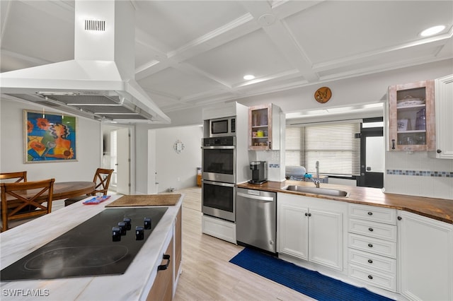 3275 Boca Ciega Dr Unit D49, Naples, FL 34112 - kitchen featuring stainless steel appliances, a sink, island range hood, coffered ceiling, and glass insert cabinets