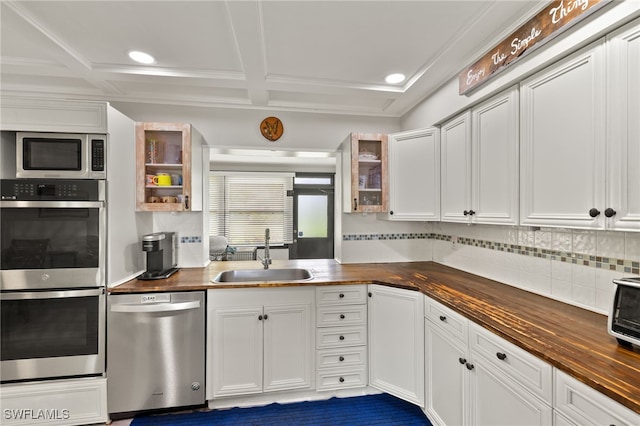 3275 Boca Ciega Dr Unit D49, Naples, FL 34112 - kitchen featuring appliances with stainless steel finishes, a sink, open shelves, butcher block counters, and backsplash