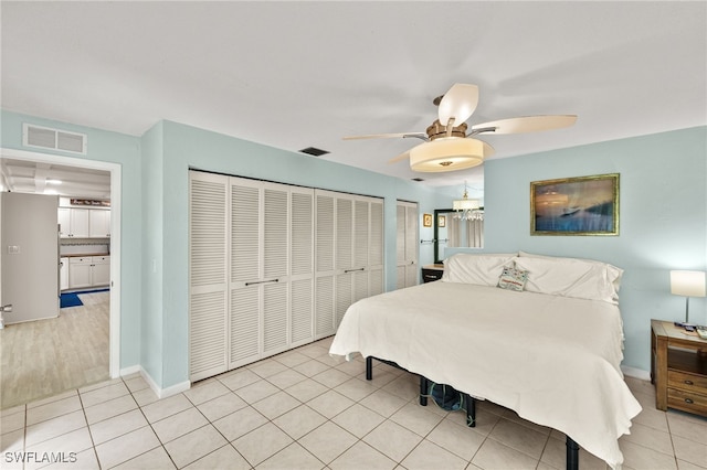 3275 Boca Ciega Dr Unit D49, Naples, FL 34112 - bedroom featuring light tile patterned floors, ceiling fan, baseboards, and two closets