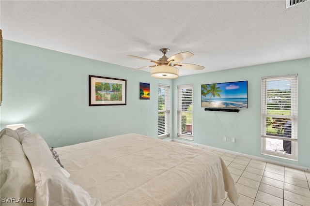 3275 Boca Ciega Dr Unit D49, Naples, FL 34112 - bedroom featuring tile patterned floors, baseboards, a ceiling fan, and a textured ceiling