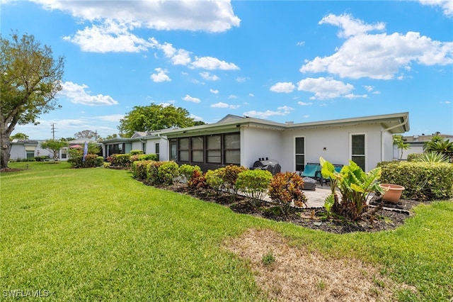 3275 Boca Ciega Dr Unit D49, Naples, FL 34112 - rear view of property featuring stucco siding, a lawn, and a patio area
