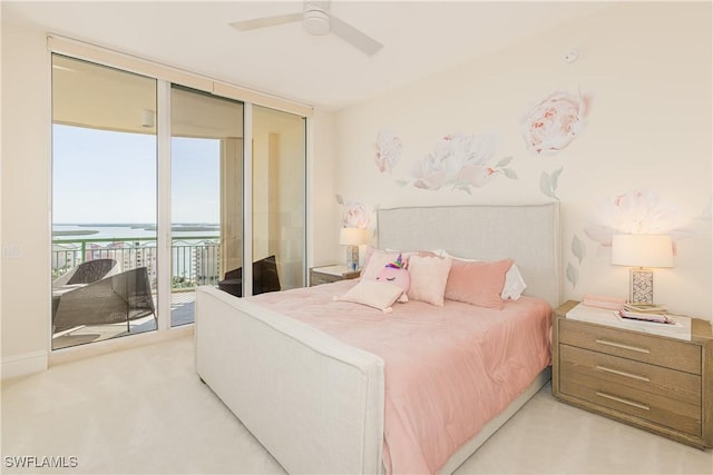 940 Cape Marco Dr Unit 1703, Marco Island, FL 34145 - bedroom featuring access to outside, a water view, floor to ceiling windows, a ceiling fan, and light carpet