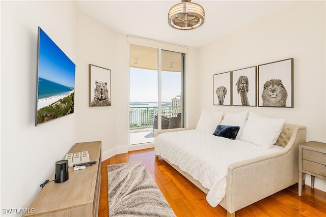940 Cape Marco Dr Unit 1703, Marco Island, FL 34145 - bedroom with access to outside, floor to ceiling windows, and wood finished floors