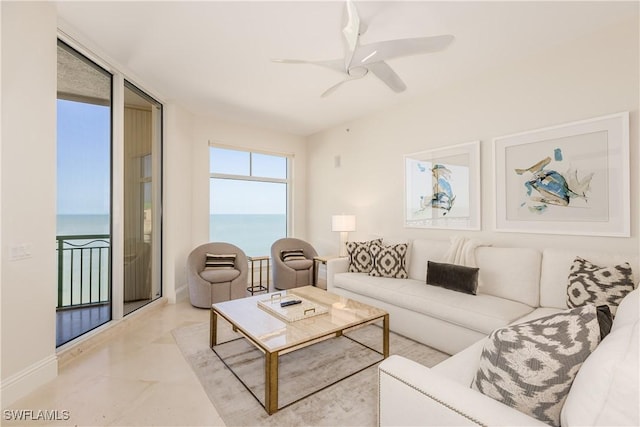 940 Cape Marco Dr Unit 1703, Marco Island, FL 34145 - living area featuring ceiling fan, a water view, and baseboards