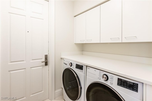 940 Cape Marco Dr Unit 1703, Marco Island, FL 34145 - laundry area with cabinet space, washer and clothes dryer, and baseboards