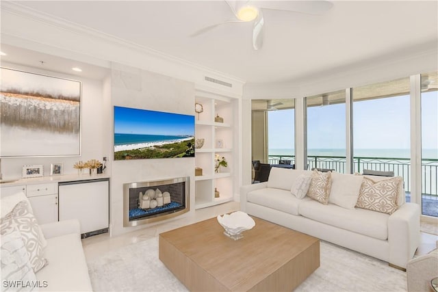 940 Cape Marco Dr Unit 1703, Marco Island, FL 34145 - living area with crown molding, built in features, ceiling fan, and a fireplace