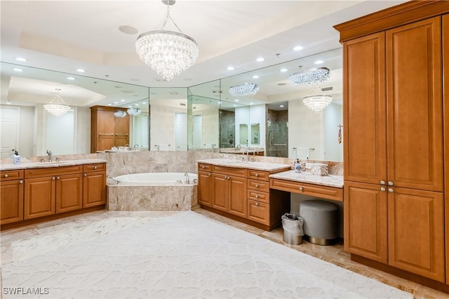 940 Cape Marco Dr Unit 1703, Marco Island, FL 34145 - bathroom with a chandelier, a shower stall, a garden tub, two vanities, and recessed lighting