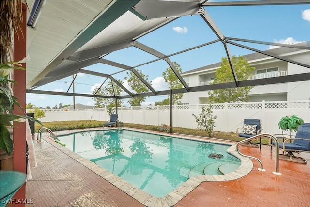 view of pool featuring a fenced backyard, a patio area, and a lanai
