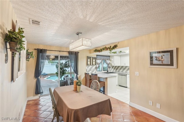 dining area featuring light tile patterned floors and baseboards