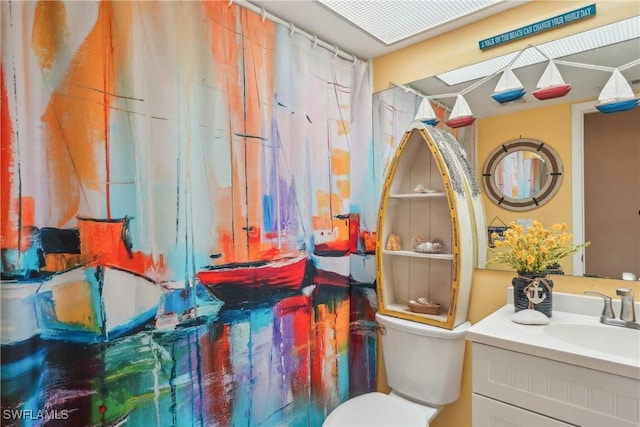 bathroom with toilet and vanity
