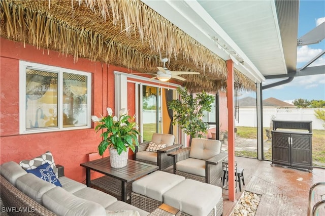 view of patio / terrace featuring an outdoor living space, a ceiling fan, and fence