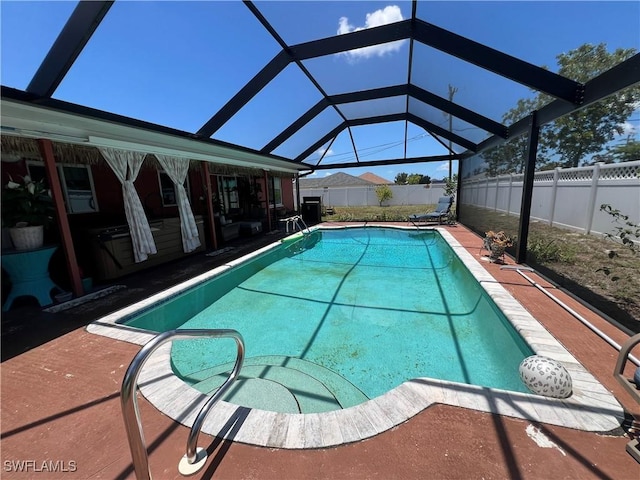 view of pool featuring a fenced backyard, a patio area, and a lanai