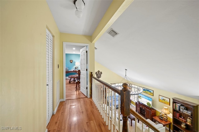 8151 New Jersey Blvd, Fort Myers, FL 33967 - corridor with a chandelier, wood finished floors, an upstairs landing, and baseboards