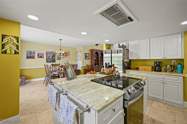 8151 New Jersey Blvd, Fort Myers, FL 33967 - kitchen with appliances with stainless steel finishes, a kitchen island, white cabinets, light tile patterned floors, and decorative light fixtures