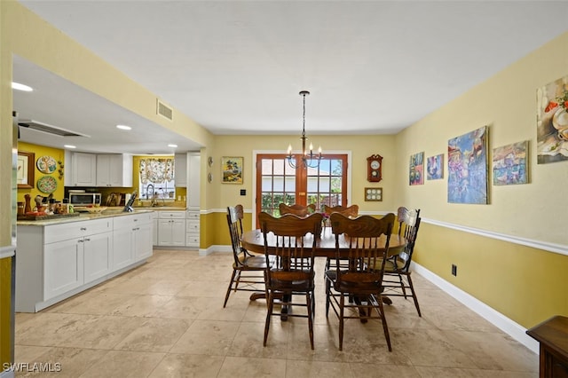 8151 New Jersey Blvd, Fort Myers, FL 33967 - dining space with a chandelier, baseboards, recessed lighting, and light tile patterned floors