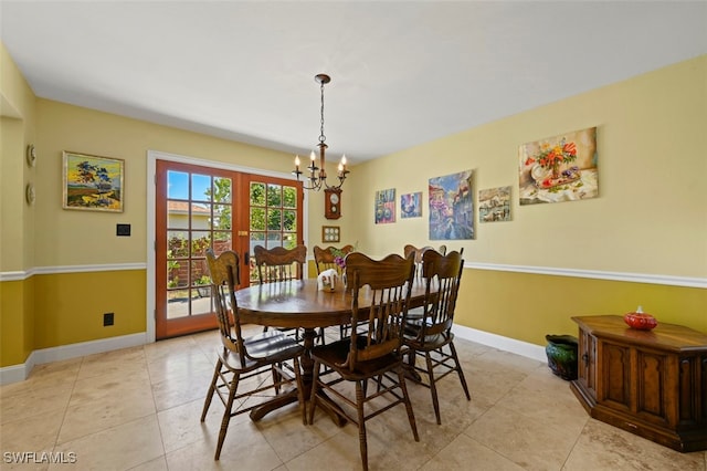 8151 New Jersey Blvd, Fort Myers, FL 33967 - dining area featuring a chandelier, baseboards, and light tile patterned floors