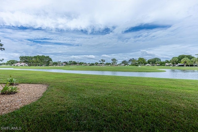 surrounding community featuring a water view and a yard