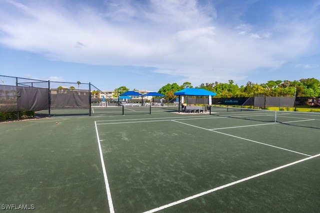 view of tennis court featuring fence