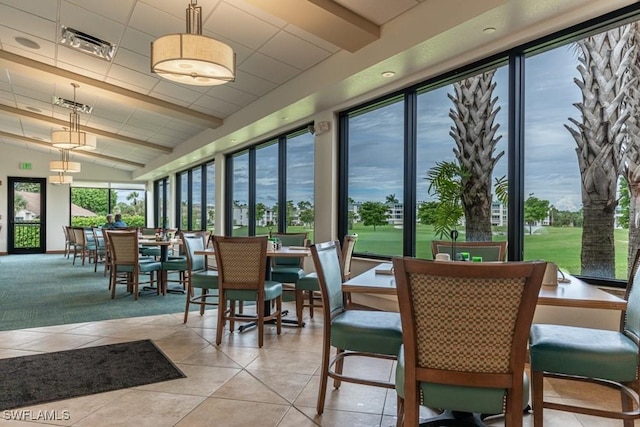 sunroom with tile patterned flooring and lofted ceiling