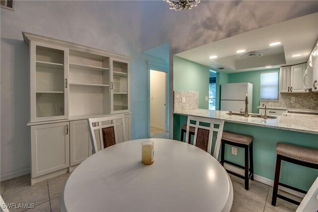 3914 SW 8th Ct Unit 103, Cape Coral, FL 33914 - dining space with baseboards and light tile patterned floors