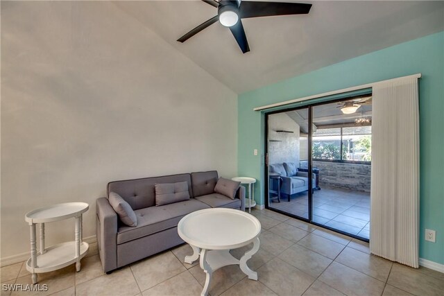 3914 SW 8th Ct Unit 103, Cape Coral, FL 33914 - living area with a ceiling fan, vaulted ceiling, baseboards, and light tile patterned floors