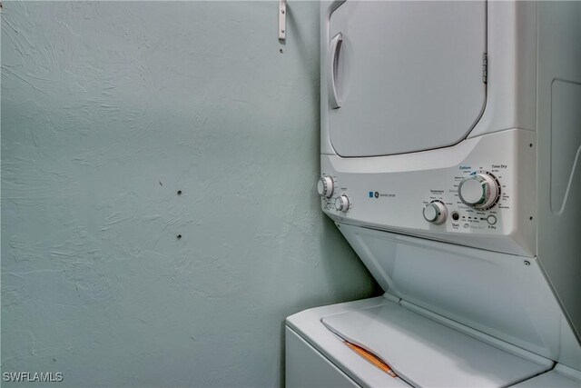 3914 SW 8th Ct Unit 103, Cape Coral, FL 33914 - laundry room featuring stacked washer / dryer