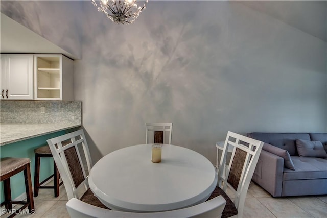 3914 SW 8th Ct Unit 103, Cape Coral, FL 33914 - dining space featuring light tile patterned floors and a chandelier