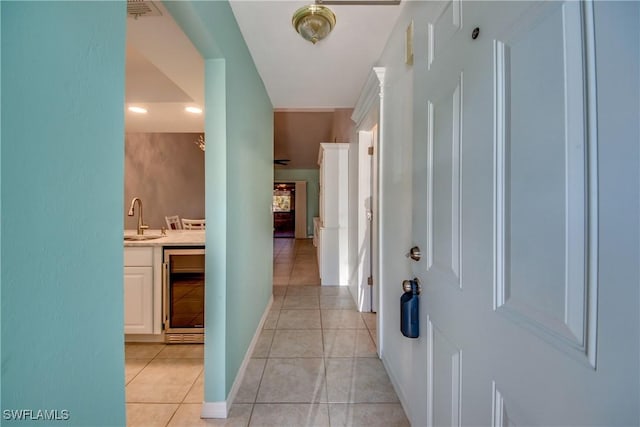 3914 SW 8th Ct Unit 103, Cape Coral, FL 33914 - corridor with a sink, wine cooler, light tile patterned floors, baseboards, and recessed lighting