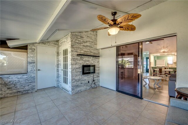 3914 SW 8th Ct Unit 103, Cape Coral, FL 33914 - unfurnished living room with ceiling fan, tile patterned floors, and a fireplace