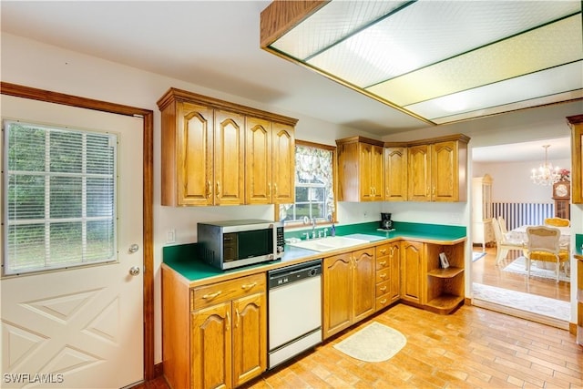 1291 S Swinging Trl, Labelle, FL 33935 - kitchen with dishwasher, stainless steel microwave, a sink, a chandelier, and brown cabinets