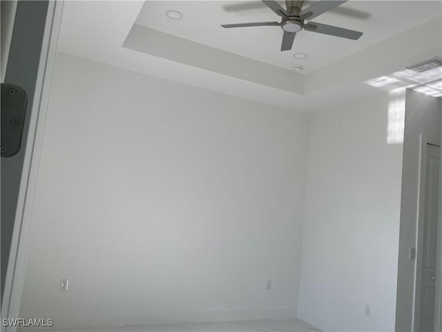 760 Fullerton Ave S, Lehigh Acres, FL 33974 - empty room with ceiling fan, a tray ceiling, and baseboards
