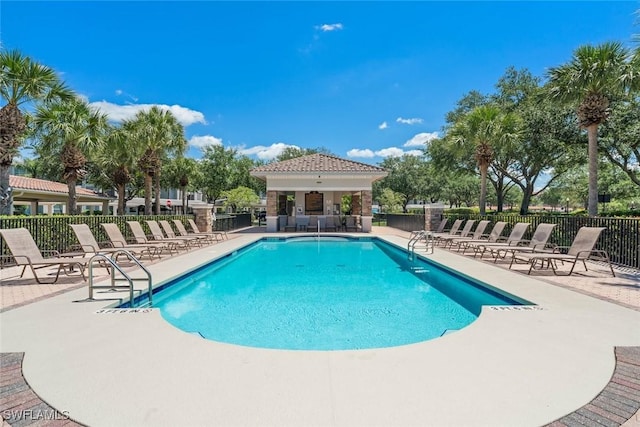 10317 Heritage Bay Blvd Unit 1418, Naples, FL 34120 - community pool with a patio area and fence
