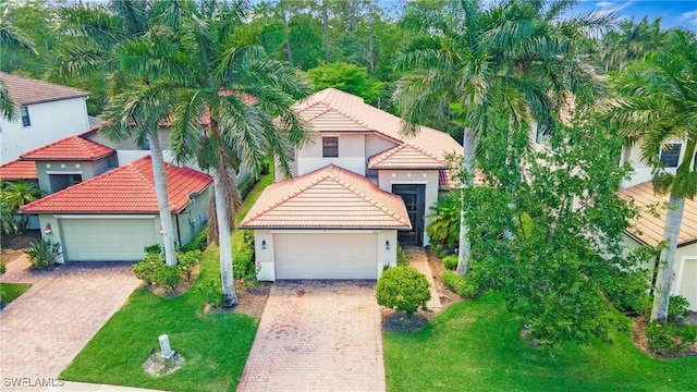 7874 Bucks Run Dr, Naples, FL 34120 - view of front of property featuring stucco siding, a front lawn, a garage, and a tiled roof
