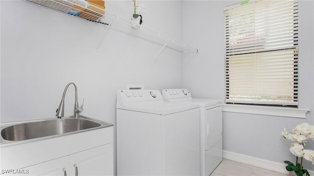7874 Bucks Run Dr, Naples, FL 34120 - laundry room with washing machine and clothes dryer, plenty of natural light, baseboards, and cabinet space