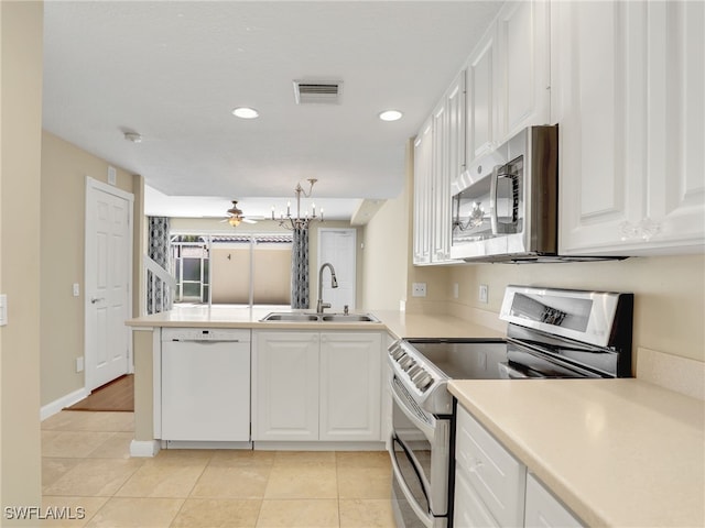 15329 Laughing Gull Ln, Bonita Springs, FL 34135 - kitchen with stainless steel appliances, ceiling fan, a peninsula, white cabinetry, and recessed lighting