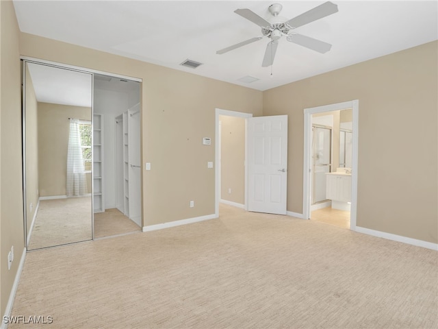 15329 Laughing Gull Ln, Bonita Springs, FL 34135 - unfurnished bedroom with light carpet, a closet, ceiling fan, and ensuite bath