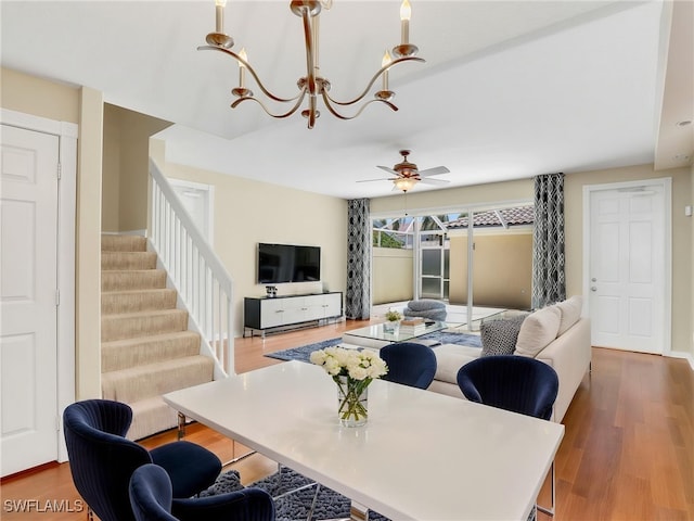 15329 Laughing Gull Ln, Bonita Springs, FL 34135 - living area with a chandelier, stairway, a ceiling fan, and wood finished floors