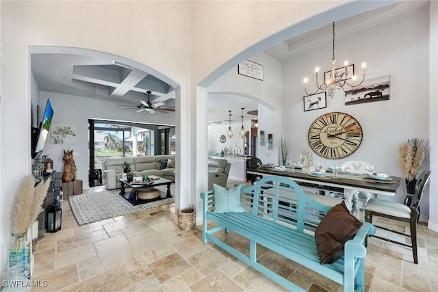 208 SW 15th St, Cape Coral, FL 33991 - foyer featuring a chandelier, arched walkways, coffered ceiling, a ceiling fan, and stone tile floors