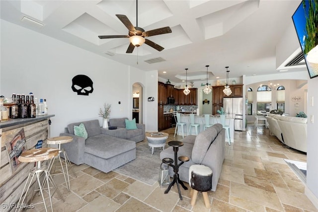 208 SW 15th St, Cape Coral, FL 33991 - living room with coffered ceiling, stone tile flooring, ceiling fan, arched walkways, and recessed lighting
