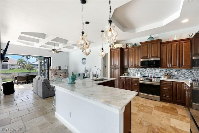 208 SW 15th St, Cape Coral, FL 33991 - kitchen with appliances with stainless steel finishes, coffered ceiling, a sink, decorative backsplash, and stone tile flooring