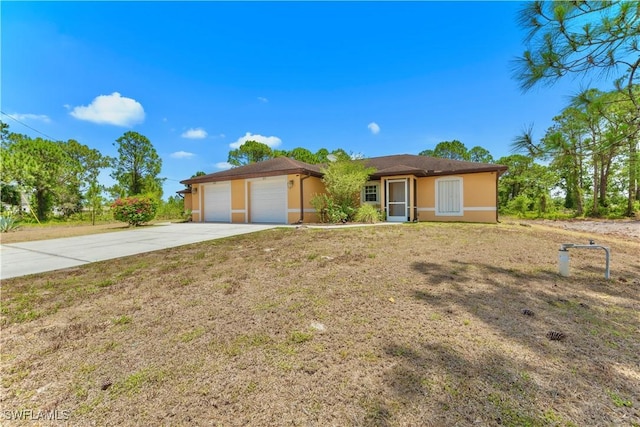 869/871 Eisenhower Blvd, Lehigh Acres, FL 33974 - ranch-style house with concrete driveway, a garage, stucco siding, and a front yard