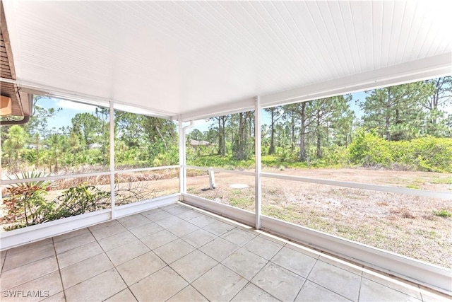 869/871 Eisenhower Blvd, Lehigh Acres, FL 33974 - unfurnished sunroom with view of wooded area