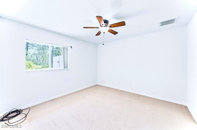 869/871 Eisenhower Blvd, Lehigh Acres, FL 33974 - unfurnished room featuring light colored carpet, ceiling fan, and baseboards
