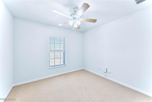 869/871 Eisenhower Blvd, Lehigh Acres, FL 33974 - unfurnished room with carpet, baseboards, and a ceiling fan