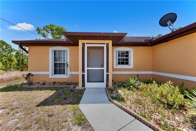 869/871 Eisenhower Blvd, Lehigh Acres, FL 33974 - property entrance featuring stucco siding and a lawn