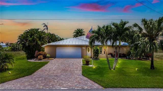 2912 SW 1st Ter, Cape Coral, FL 33991 - ranch-style house with stucco siding, a garage, decorative driveway, and a yard