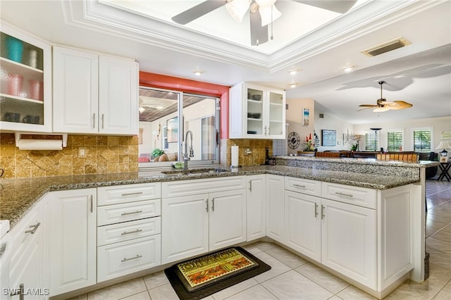 2912 SW 1st Ter, Cape Coral, FL 33991 - kitchen featuring a sink, a ceiling fan, decorative backsplash, a peninsula, and a raised ceiling